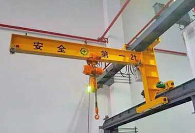 Wall travelling jib crane for material handling
