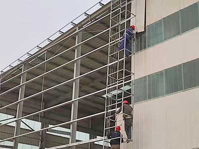 Wall panel installation of steel structure building with overhead crane system 