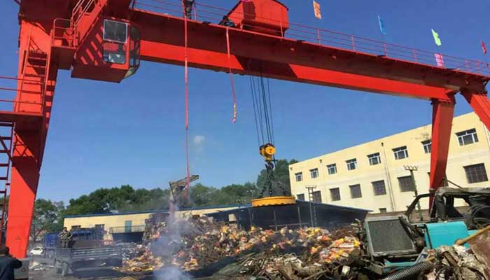 Magnetic gantry crane on tracks for steel scrap handling in steel mill plant yard 
